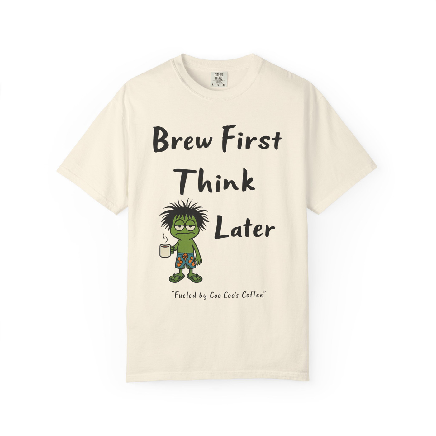 Brew First, Think Later – Bert’s Morning Motto Tee by Coo Coo’s Coffee in ivory, featuring frazzled Bert the gecko holding coffee.