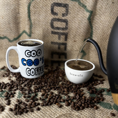 Coo Coo's Coffee mug with a brewista cupping bowl and coffee beans
