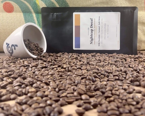 Nightcap Decaf Swiss Water Coffee beans, coffee bag and cupping cup