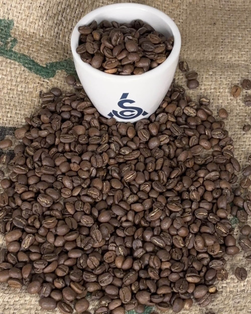SCA cupping bowl and medium roasted coffee beans