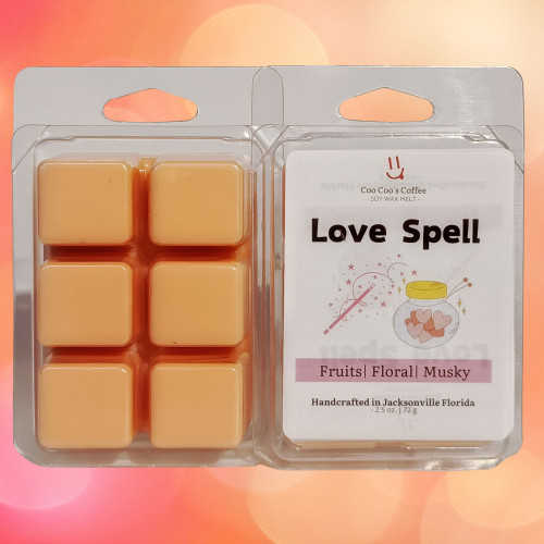 "Romantic Love Spell wax melt with peachy cubes and magical fragrance label against a dreamy bokeh backdrop."