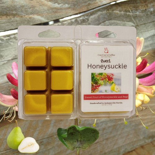 Sweet Honeysuckle & Pear wax melts with honeysuckle flowers and pears on rustic wood