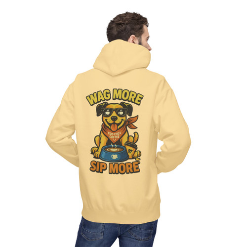 Yellow Haze hoodie featuring a cheerful dog wearing sunglasses and a red bandana with a coffee bowl labeled "Coo Coo’s Coffee." The text reads “Wag More, Sip More” in playful lettering.