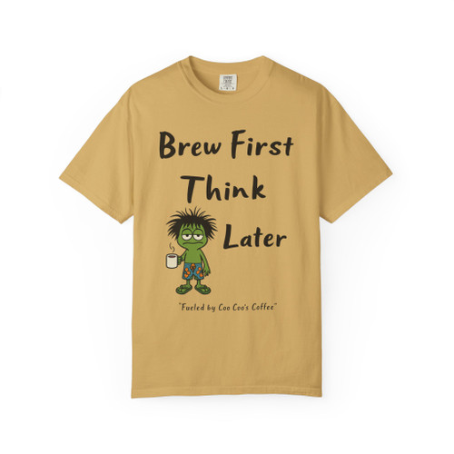“Think Later Tee – Brew Mode Activated” in mustard yellow by Coo Coo’s Coffee featuring frazzled Bert gecko holding coffee cup with bold slogan.