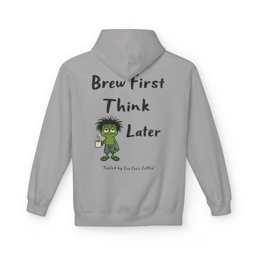 "Think Later – Brew First Hoodie by Coo Coo’s Coffee in cement grey. Features frazzled Bert the gecko holding a coffee mug with bold text 'Brew First, Think Later.' Cozy unisex hoodie for coffee lovers."