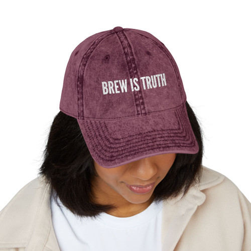Person wearing a Brew Is Truth vintage dad hat while looking down