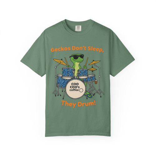 Light Green tee featuring gecko drummer illustration and playful headline—fresh stage look