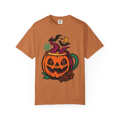 “Yam orange tee featuring jack-o’-lantern pumpkin coffee mug with steam, bats, moon, and spice accents, Pumpkin Mug Tee by Coo Coo’s Coffee.”