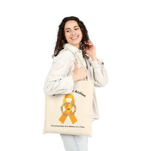 Smiling woman with Jaxen Gold Ribbon canvas tote on shoulder — childhood cancer awareness — Coo Coo’s Coffee