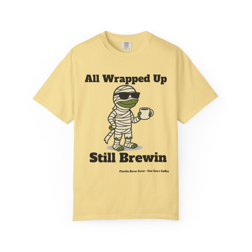 All Wrapped Up Still Brewin Halloween tee - mummy Bert the gecko wrapped in bandages with sunglasses holding coffee mug - front print on burnt orange ring-spun cotton by Coo Coos Coffee Florida Brew Crew