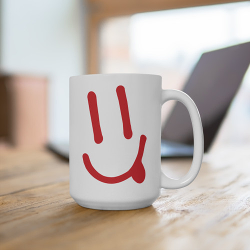 Coo Coos Coffee happy face 15oz ceramic mug on desk - bold red hand-drawn smiley face icon - daily driver coffee mug