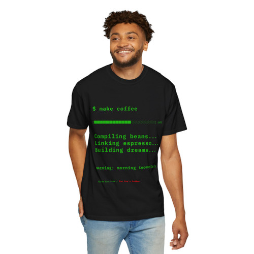 $ make coffee tee — front shows fake compiler output in terminal green: command prompt, progress bar at 60%, three build steps (compiling beans, linking espresso, building dreams), and "warning: morning incomplete" punchline; back features Computer Bert at his laptop — Coo Coo's Coffee Tech Error 404 collection two-sided DTG tee on dark cotton. front black male model