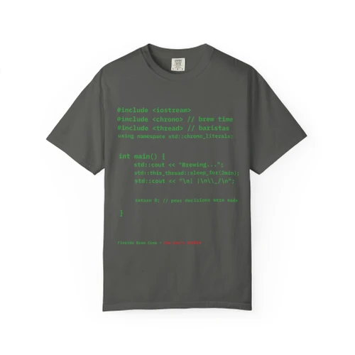 Hello Coffee in C++ tee — front shows real compiling C++ program in terminal green that prints the Coo Coo's Coffee smile in ASCII; back features Computer Bert at his laptop wearing the Brew Is Truth cap — Coo Coo's Coffee Tech Error 404 collection two-sided DTG tee for programmers and coffee lovers. Pepper front