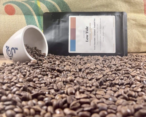 Low Tide roasted coffee bean, bag, and cupping cup