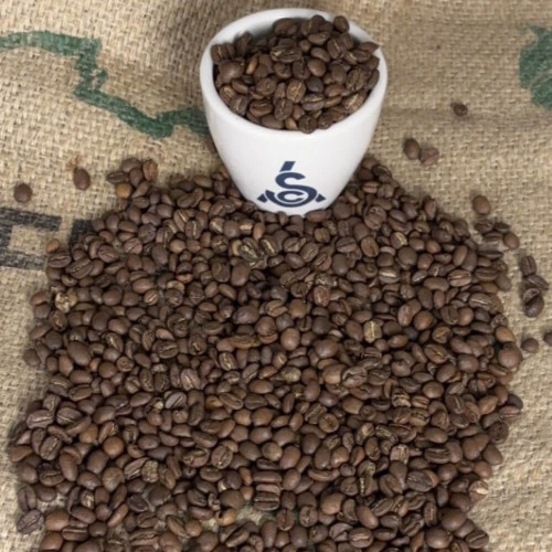 SCA cupping bowl and light roasted coffee beans
