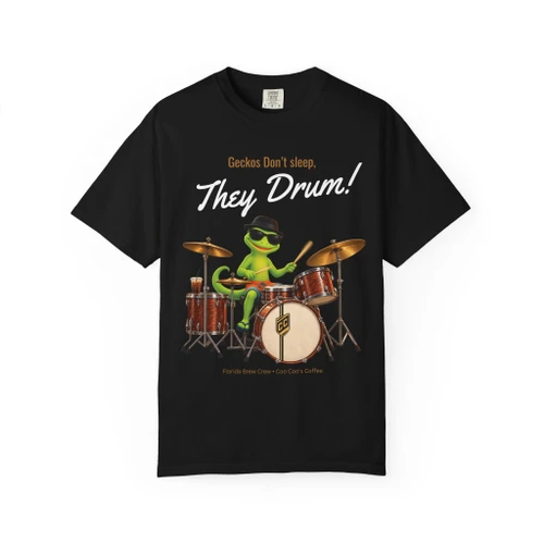Geckos Don’t Sleep, They Play Drums coffee t-shirt — cartoon gecko Bert drumming, caffeine-and-music printed on the front, black