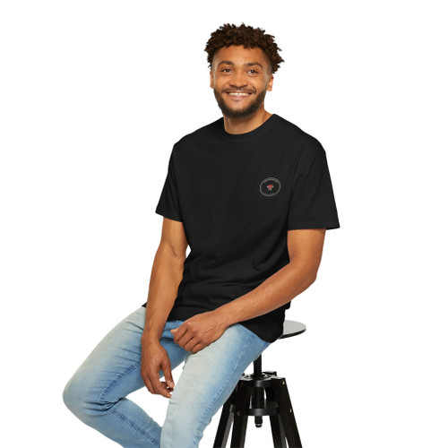 Close-up of the V-60 pour-over dripper rendered as a muscle-car badge graphic print on the Runs on V-60, Not V-8 t-shirt, black chair