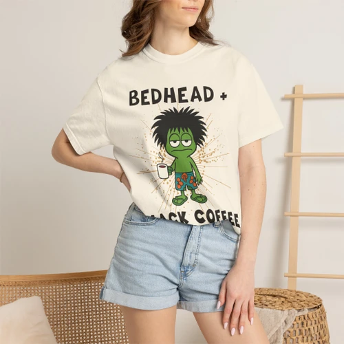 Close-up of the bedhead gecko Bert clutching black coffee graphic print on the Bedhead & Black Coffee t-shirt
