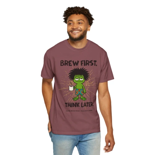 Person wearing the Brew First, Think Later coffee t-shirt from Coo Coo’s Coffee, brick male