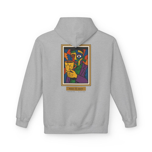 Built to Brew.
Coffee made me.
A bold cubist coffee-drinker — stitched-together face, bean for an eye, cracked cup in hand — on a cozy fleece pullover hoodie. Picasso by way of your morning cup. Warm, heavyweight, and made to live in. Sport grey