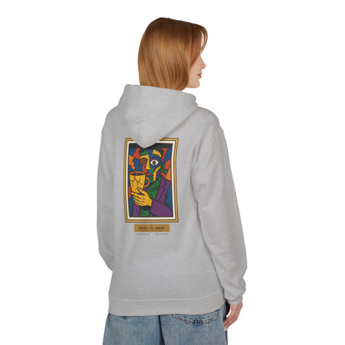 Built to Brew.
Coffee made me.

A bold cubist coffee-drinker — stitched-together face, bean for an eye, cracked cup in hand — on a cozy fleece pullover hoodie. Picasso by way of your morning cup. Warm, heavyweight, and made to live in. Sport grey female