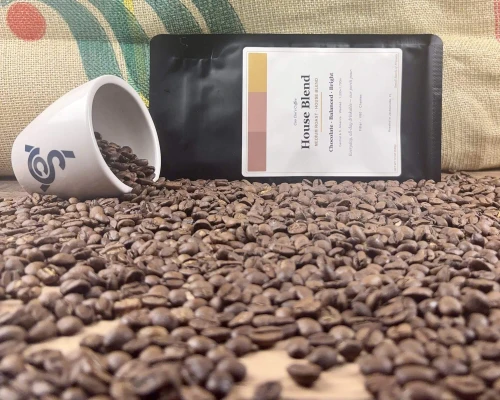 House blend coffee beans, bag and cupping cup