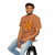 brown-orange tee shirt with caffeine molecule design labeled “Molecule of Madness – Fueled by Coo Coo’s Coffee”