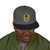 black snapback hat with embroidered Bert surfing badge and yellow bill – Coo Coo’s Coffee