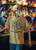 Skeleton mannequin at a lively bar scene wearing the Brew Good Bones – Dancing Skeletons Tee by Coo Coo’s Coffee in Mustard; colorful skeletons dance with coffee beans, adding a fun and spooky twist to coffee culture fashion.