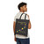 Model carrying black childhood cancer bravery beads tote over shoulder, front design visible