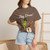 Close-up of the cartoon gecko Bert drumming, caffeine-and-music graphic print on the Geckos Don’t Sleep, They Play Drums t-shirt, espresso