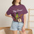 Close-up of the cartoon gecko Bert drumming, caffeine-and-music graphic print on the Geckos Don’t Sleep, They Play Drums t-shirt, berry