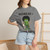 Close-up of the bedhead gecko Bert clutching black coffee graphic print on the Bedhead & Black Coffee t-shirt