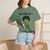 Close-up of the bedhead gecko Bert clutching black coffee graphic print on the Bedhead & Black Coffee t-shirt