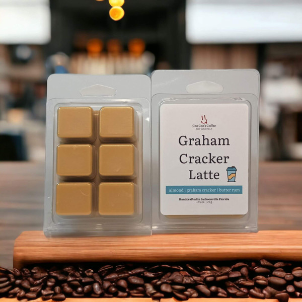Graham Cracker Latte wax melt clamshell on café counter with coffee beans at the front