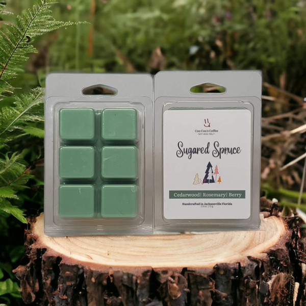 "Sugared Spruce Wax Melt displayed on a tree stump with forest greenery, highlighting woodsy cedar and berry fragrance."
