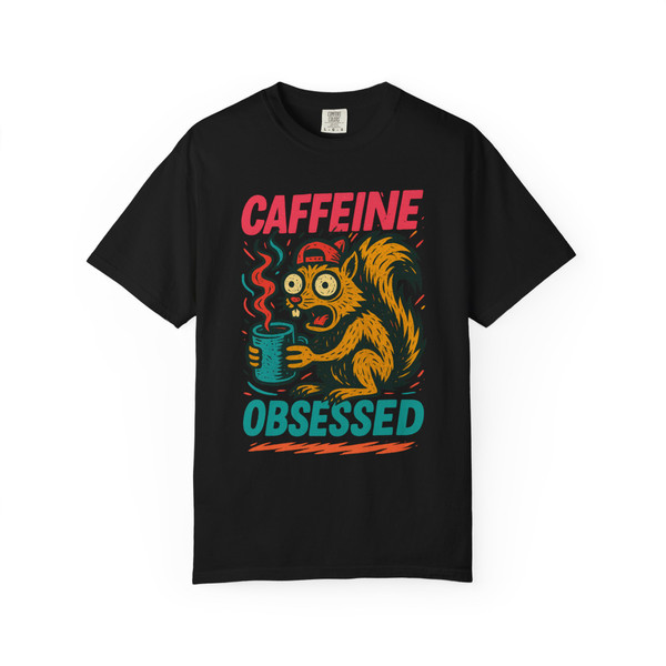Black short-sleeve tee showcasing the “Caffeine Obsessed” squirrel illustration, with red and teal text popping against the dark background.
