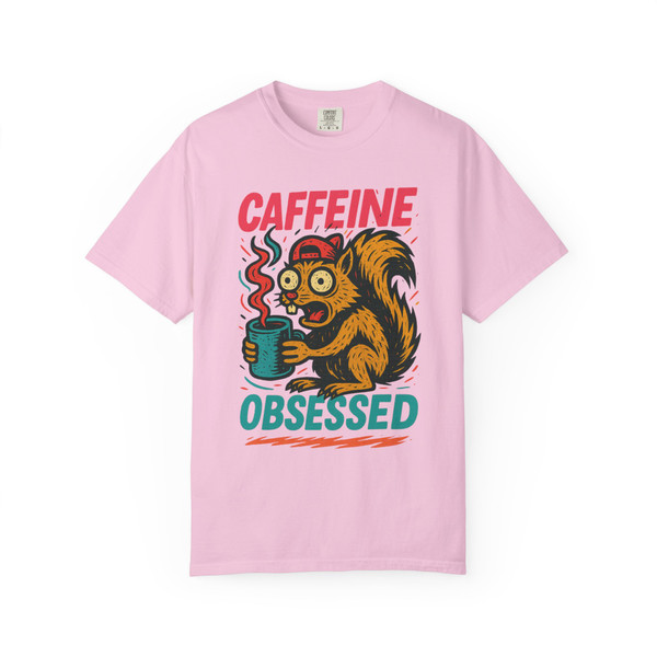 Blossom pink tee featuring the “Caffeine Obsessed” squirrel artwork, paired with bold red and teal text for a playful, high-energy vibe.