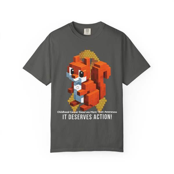 Dark pepper-grey tee showcasing a pixel squirrel graphic holding coffee with a gold ribbon backdrop and “It Deserves Action” slogan – Childhood Cancer Awareness Shirt by Coo Coo’s Coffee.
