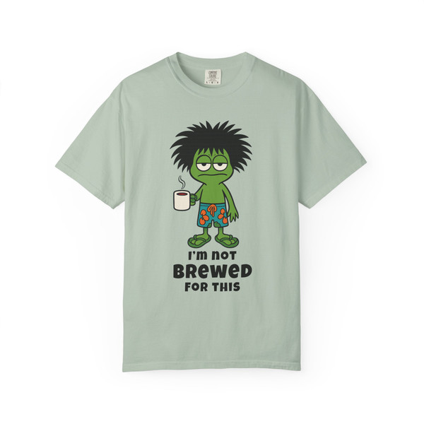 I’m Not Brewed for This – Frazzled Bert Tee by Coo Coo’s Coffee in Bay blue. Relaxed-fit coffee graphic tee featuring quirky Bert the gecko, caffeine-fueled vibes.