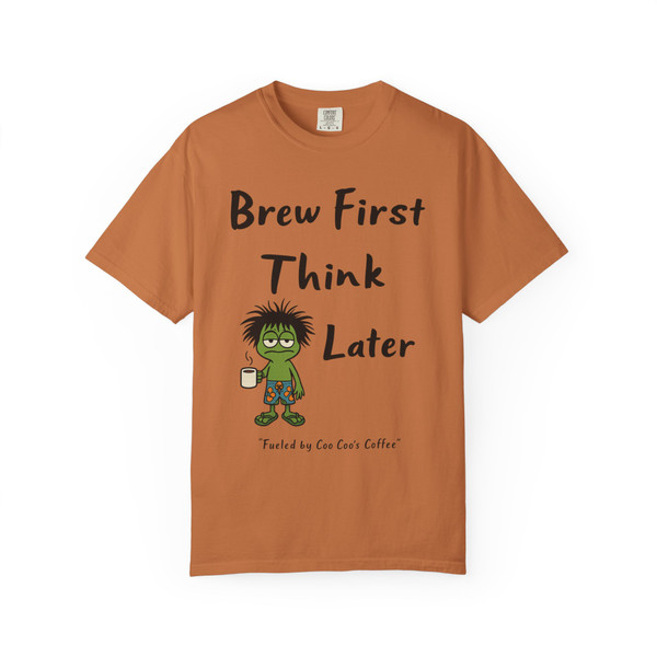 Coffee lover’s “Think Later Tee – Brew Mode Activated” in yam color, Coo Coo’s Coffee design with frazzled Bert gecko and humorous text.