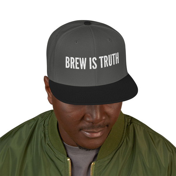 Black/Charcoal Gray/Charcoal Gray Snapback – Brew Is Truth snapback by Coo Coo’s Coffee in black with charcoal gray brim, bold embroidered slogan for streetwear coffee lovers. Top side view