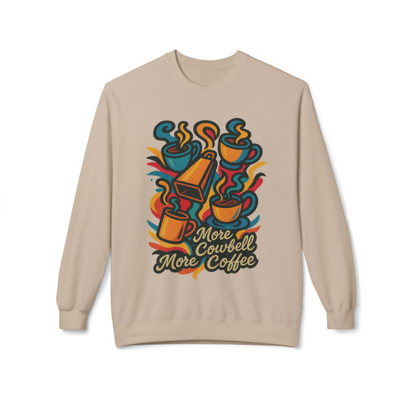 Sand-colored sweatshirt with a bold, colorful More Cowbell, More Coffee design. Features stacked steaming coffee cups with a bright orange cowbell centerpiece. Fun, high-energy Coo Coo’s Coffee vibe.