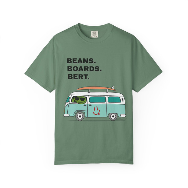 Light Green tee showing teal surf van with roof board and Beans. Boards. Bert. text—fresh coastal look.