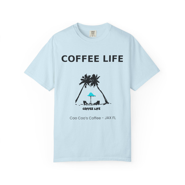 Coffee Life JAX Beach Brew Tee in chambray blue with island palm trees and umbrella print by Coo Coo’s Coffee.