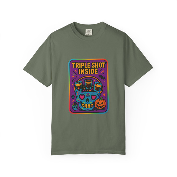 “Moss green tee showing neon skull design with three coffee cup symbols and pumpkin detail, bold text ‘Triple Shot Inside,’ Neon Skull Tee by Coo Coo’s Coffee.”