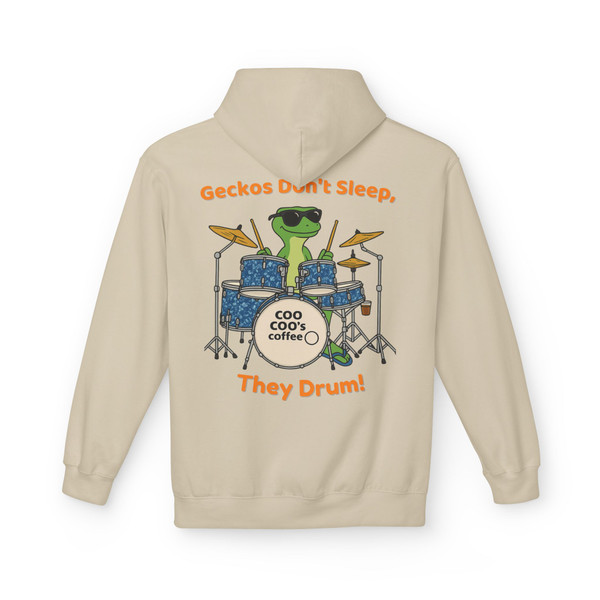“Sand hoodie featuring Bert the gecko mascot drumming on a blue kit with text ‘Geckos Don’t Sleep, They Drum!,’ Hoodie by Coo Coo’s Coffee.”