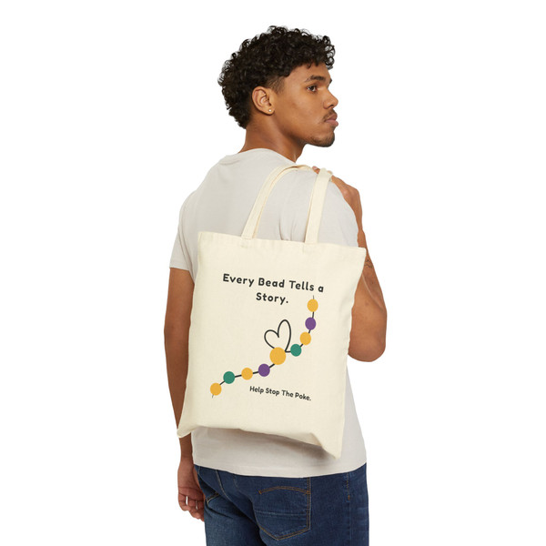 Model wearing natural bravery beads childhood cancer tote over shoulder, back showing Every Bead Tells a Story design