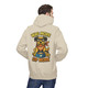 Sand hoodie featuring a cheerful dog wearing sunglasses and a red bandana with a coffee bowl labeled "Coo Coo’s Coffee." The text reads “Wag More, Sip More” in playful lettering.