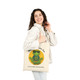 Canvas tote bag featuring Coo Coo’s Coffee’s gecko mascot Bert meditating with a yellow sun behind him and the phrase “Inner Bean, Outer Zen.” female model